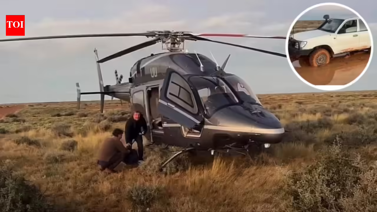 Australian father and son were stranded in the outback for 12 hours after a storm trapped their car; billionaire Tim Roberts, who happened to be flying his helicopter, rescued them